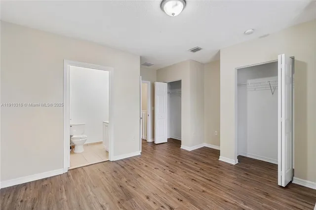a view of wooden floor and windows in a room