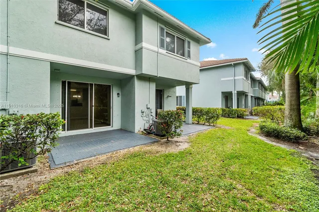 a view of a house with backyard porch and sitting area