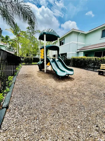 a view of a chair and table in backyard of the house