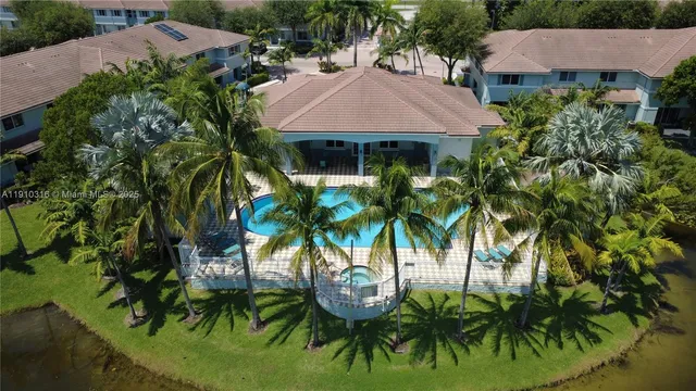 an aerial view of a house with a yard and potted plants