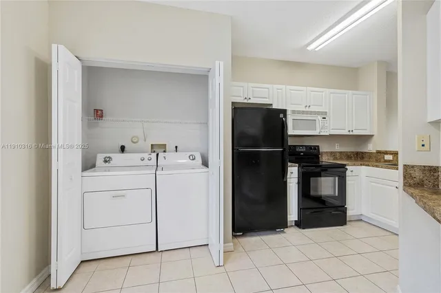 a kitchen with a refrigerator sink and cabinets