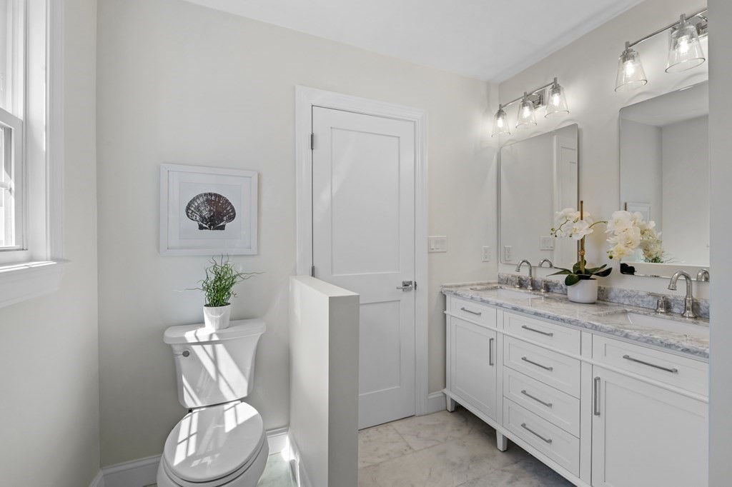 14 Colgate Road Marblehead, MA 01945 - Photo 14 of 35 a bathroom with a granite countertop sink and a mirror