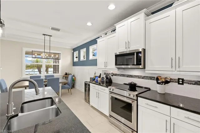 a kitchen with a sink stove and microwave