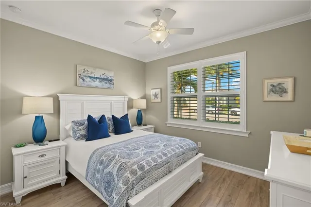 a spacious bedroom with a large bed a chandelier and a mirror