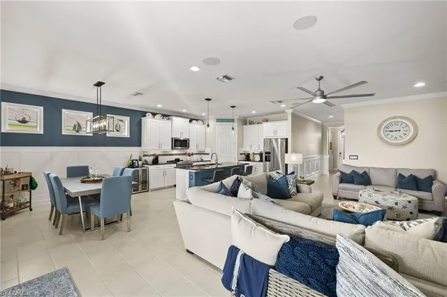 a living room with lots of furniture and view of kitchen