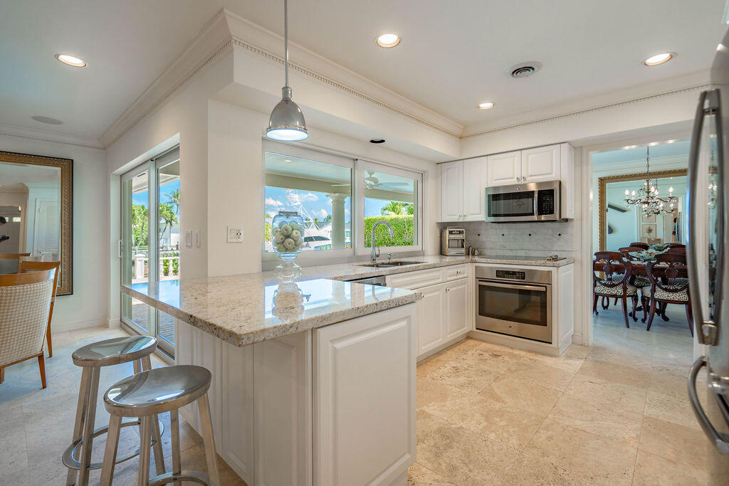 4450 Northeast 24th Terrace Lighthouse Point, FL 33064 - Photo 13 of 47 a kitchen with sink cabinets and counter space