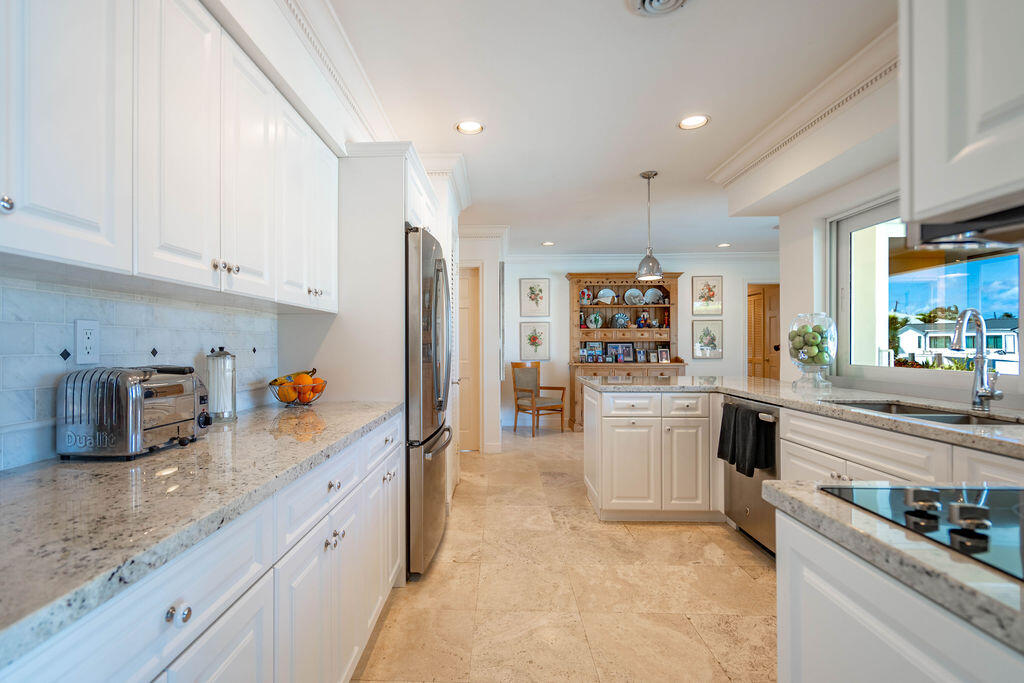4450 Northeast 24th Terrace Lighthouse Point, FL 33064 - Photo 14 of 47 a kitchen with refrigerator and cabinets