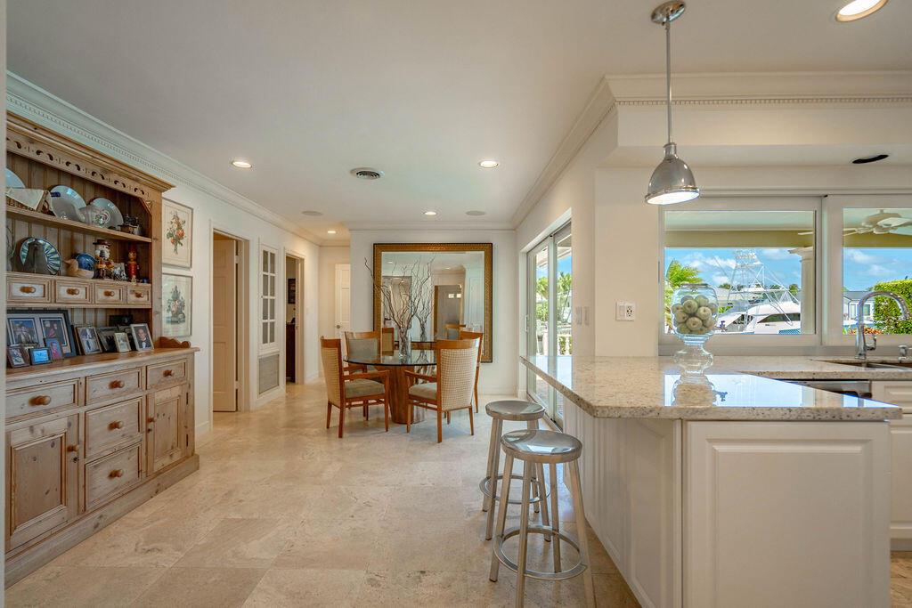 4450 Northeast 24th Terrace Lighthouse Point, FL 33064 - Photo 17 of 47 a dining hall with stainless steel appliances granite countertop a stove and a cabinets