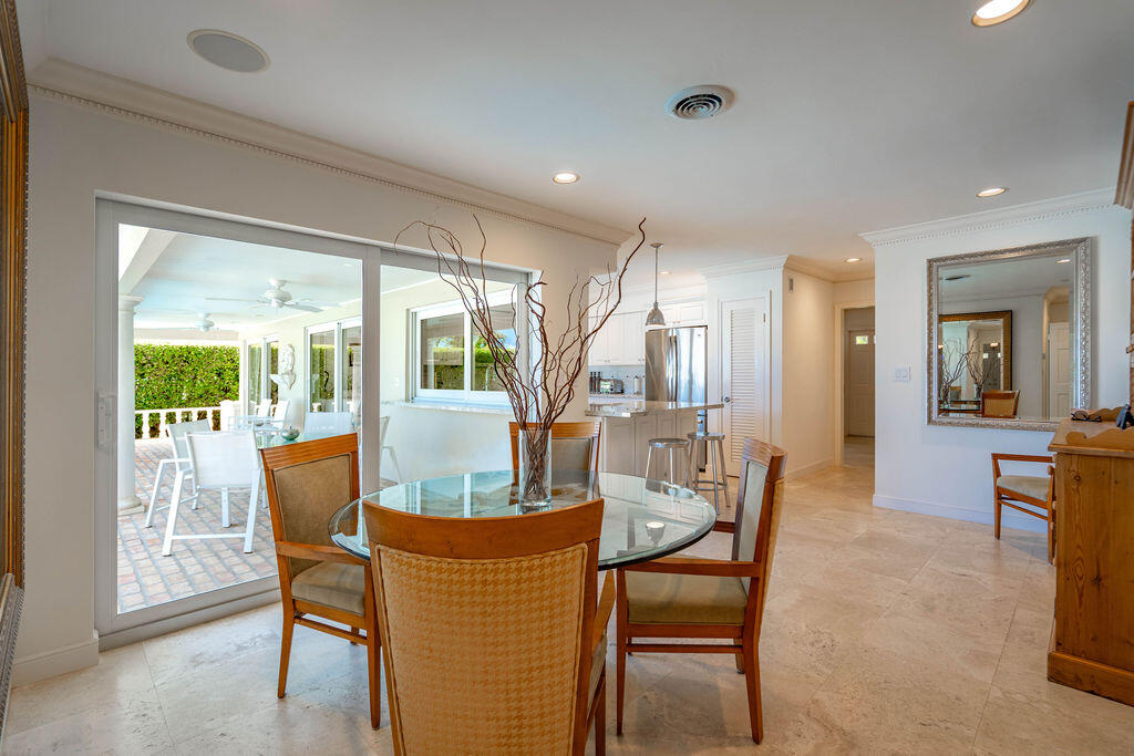 4450 Northeast 24th Terrace Lighthouse Point, FL 33064 - Photo 19 of 47 a dining room with furniture window and wooden floor
