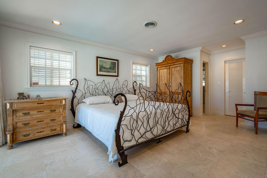 4450 Northeast 24th Terrace Lighthouse Point, FL 33064 - Photo 20 of 47 a bedroom with a bed and a dresser in it