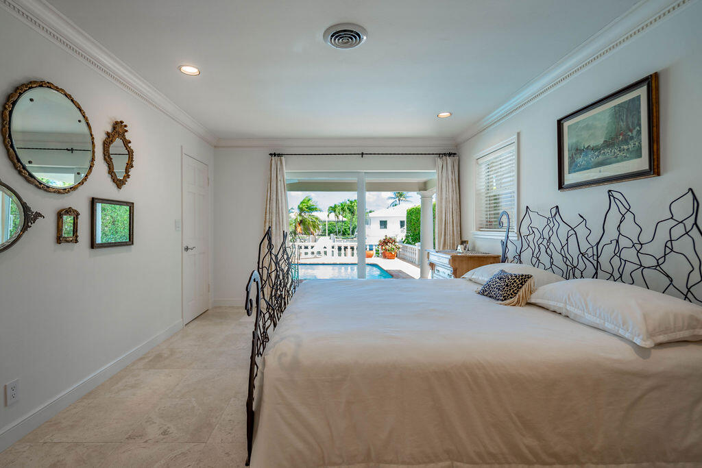 4450 Northeast 24th Terrace Lighthouse Point, FL 33064 - Photo 21 of 47 a bed room with a bed mirror and a large window