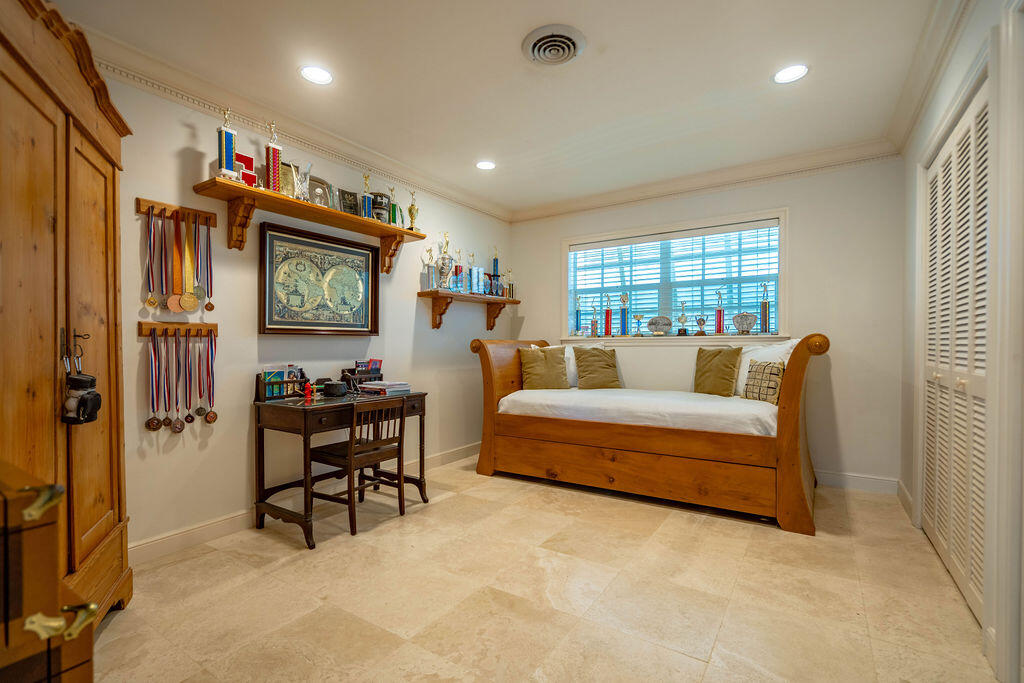 4450 Northeast 24th Terrace Lighthouse Point, FL 33064 - Photo 23 of 47 a bedroom with furniture and a flat screen tv