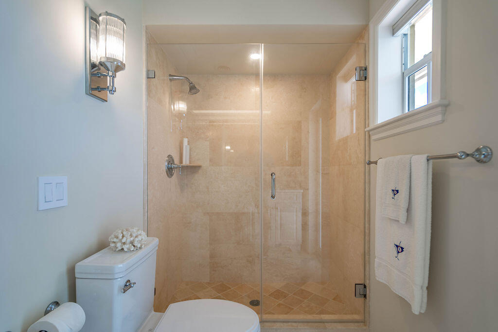 4450 Northeast 24th Terrace Lighthouse Point, FL 33064 - Photo 26 of 47 a bathroom with a toilet sink shower and mirror