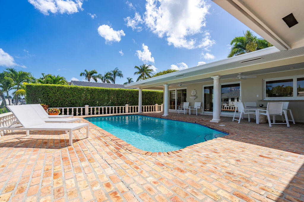 4450 Northeast 24th Terrace Lighthouse Point, FL 33064 - Photo 38 of 47 a view of a swimming pool with a patio