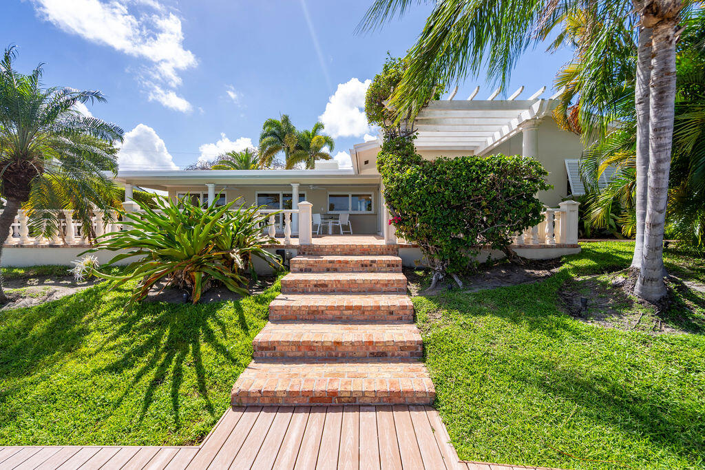 4450 Northeast 24th Terrace Lighthouse Point, FL 33064 - Photo 46 of 47 a front view of a house with a yard