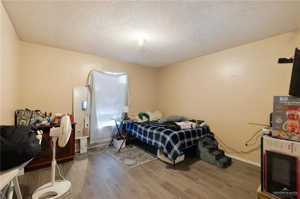 a room with a bed furniture and a flat screen tv