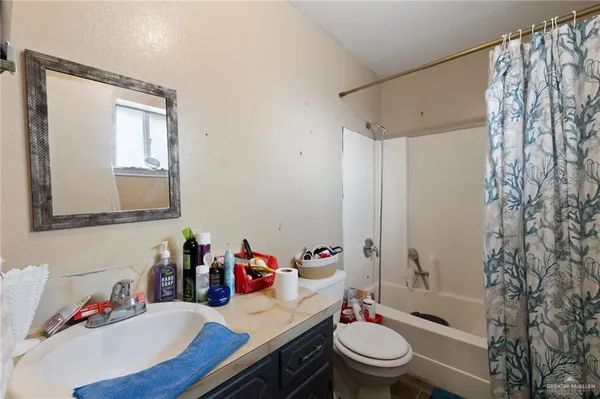 a bathroom with a sink toilet vanity and shower