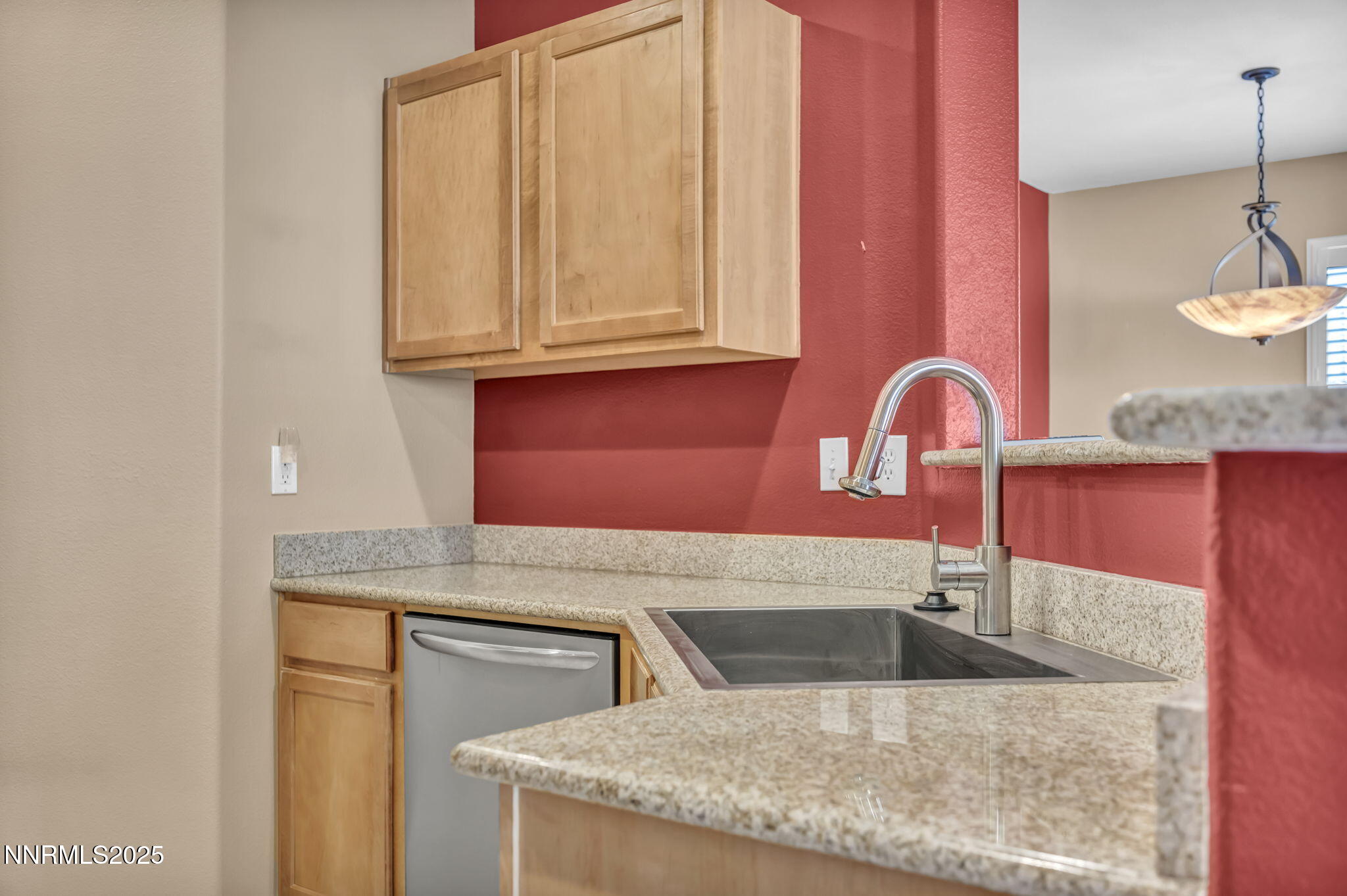 9050 Double R Boulevard, Unit 1123 Reno, NV 89521 - Photo 20 of 39 a kitchen with granite countertop a sink a stove and a wooden cabinets