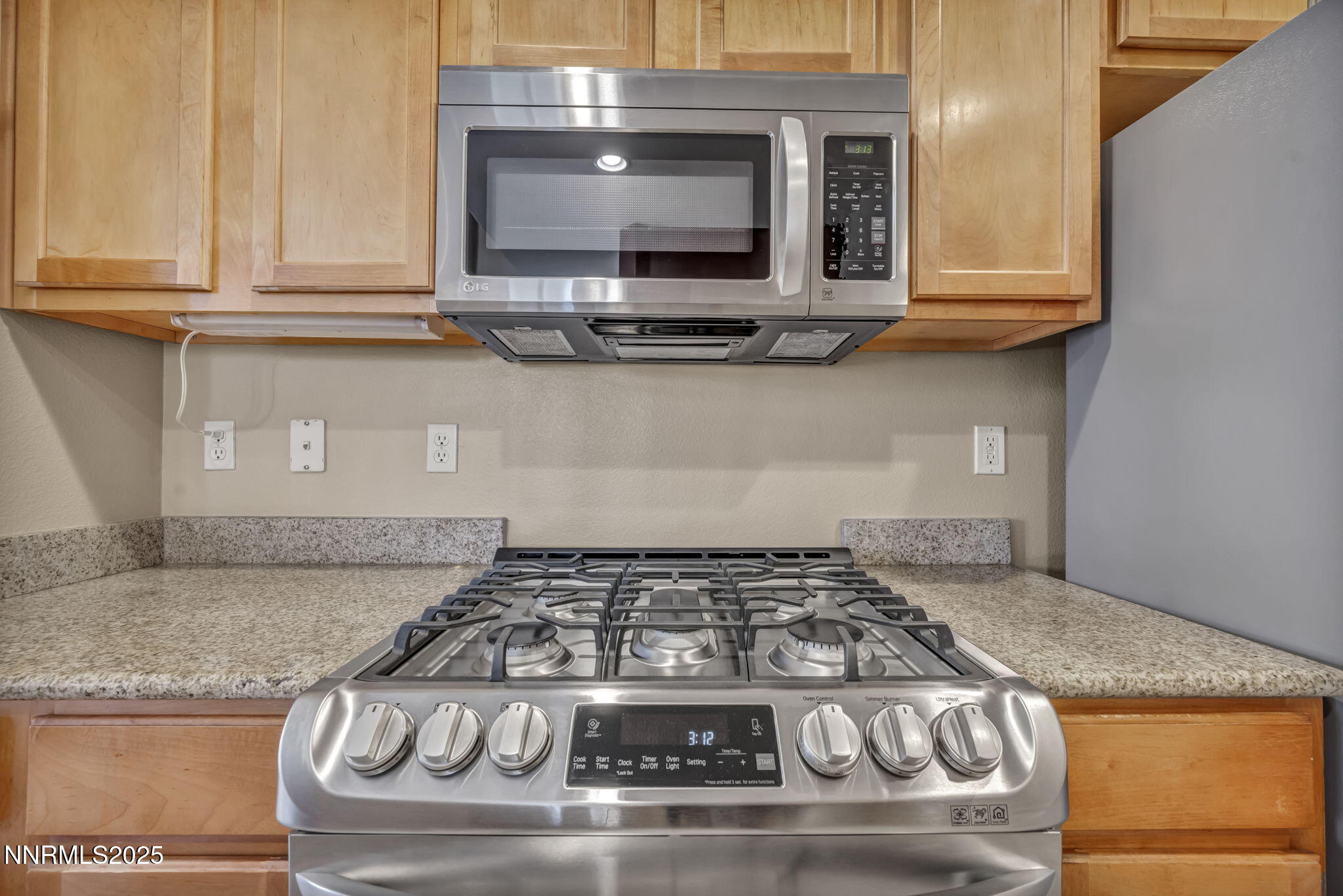 9050 Double R Boulevard, Unit 1123 Reno, NV 89521 - Photo 21 of 39 a kitchen with granite countertop a stove and a microwave