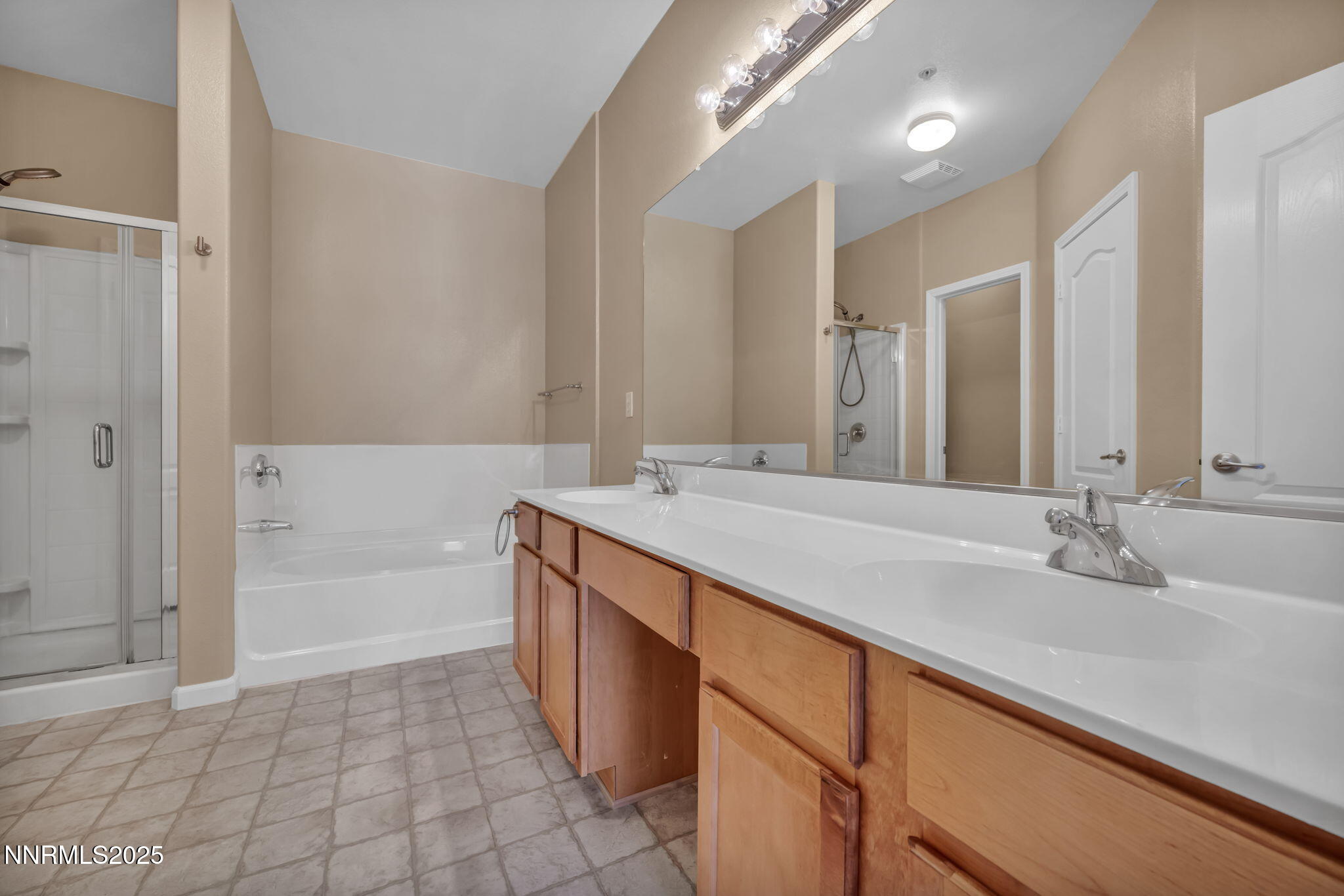 9050 Double R Boulevard, Unit 1123 Reno, NV 89521 - Photo 27 of 39 a bathroom with a granite countertop sink a toilet a mirror and bathtub