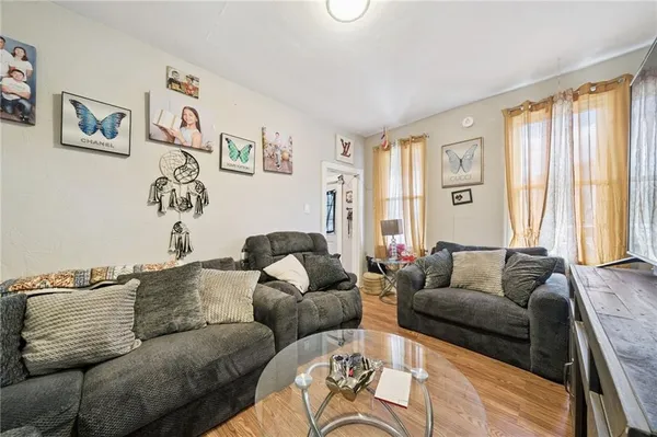 a living room with furniture and large window
