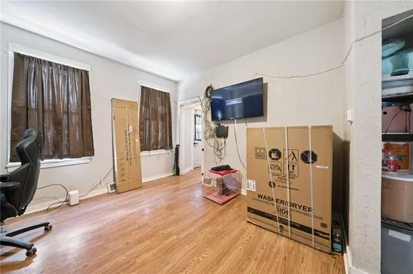 a view of a livingroom with furniture and a flat screen tv