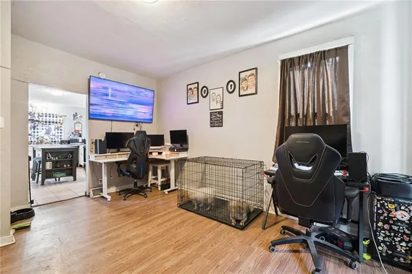 a view of a workspace with furniture and a window