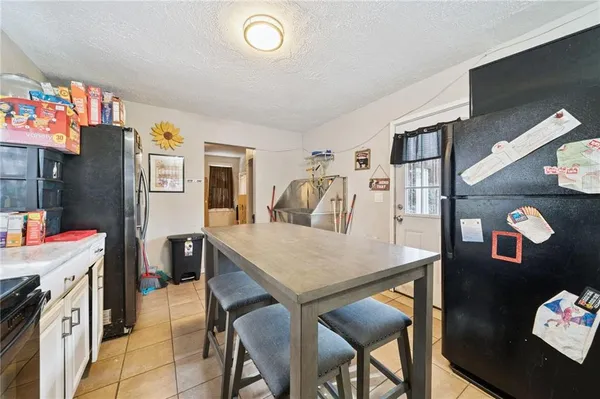 a view of a dining room with furniture and a kitchen