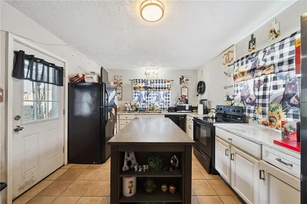 a kitchen with refrigerator and window