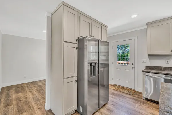 a kitchen with stainless steel appliances granite countertop a refrigerator and a stove top oven