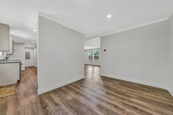 a view of empty room with wooden floor