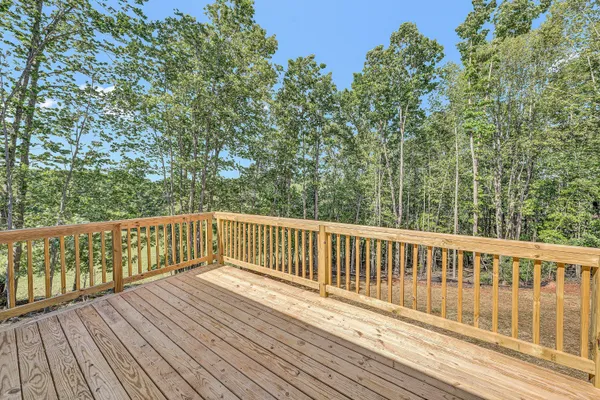 a view of balcony with wooden floor and fence