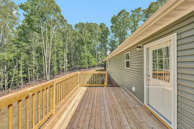 a view of a house with backyard and trees
