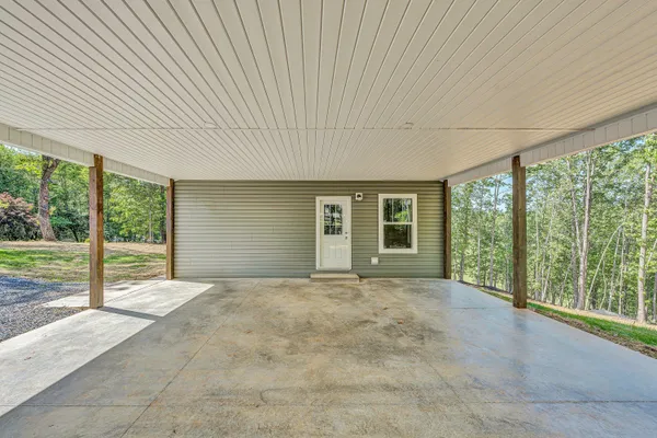a view of an empty room with large windows