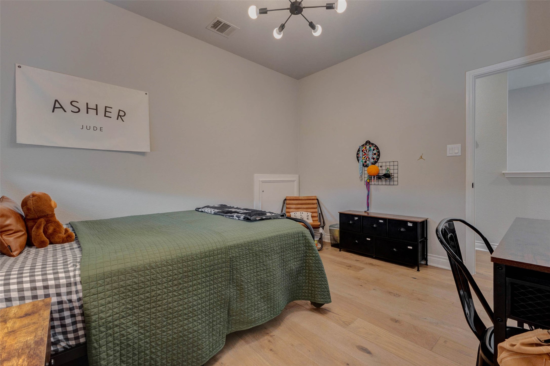 4303 Tupelo Leaf Court Manvel, TX 77578 - Photo 42 of 50 a bedroom with a bed and wooden floor