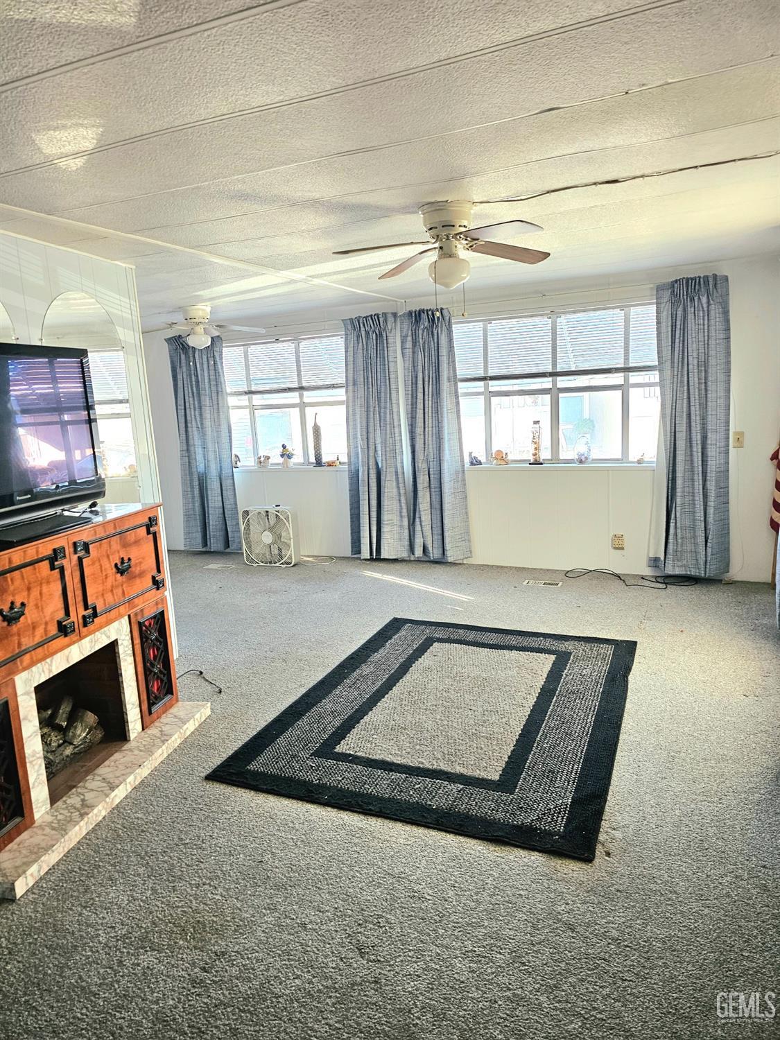 Undisclosed Address Anaheim, CA 92801 - Photo 5 of 8 a view of an empty room with a fireplace and a window