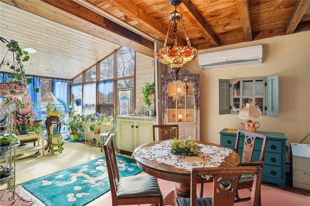 186 Arcadia Road Hopkinton, RI 02832 - Photo 11 of 27 Relaxing sunroom featuring floor-to-ceiling windows, designed to fully immerse you in and appreciate the breathtaking beauty of the surrounding natural environment.