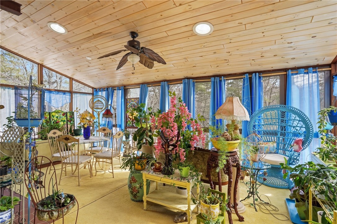 186 Arcadia Road Hopkinton, RI 02832 - Photo 12 of 27 This inviting sunroom offers breathtaking views that extend to every corner, blending the beauty of the interior space with the outdoors, creating an atmosphere of tranquility