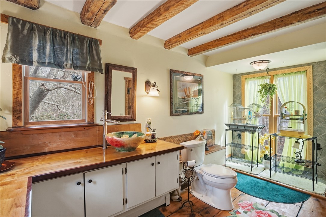 186 Arcadia Road Hopkinton, RI 02832 - Photo 13 of 27 Bathroom on first floor with lovely custom sink and expansive, light-filled windows that provide additional views to nature and the river.