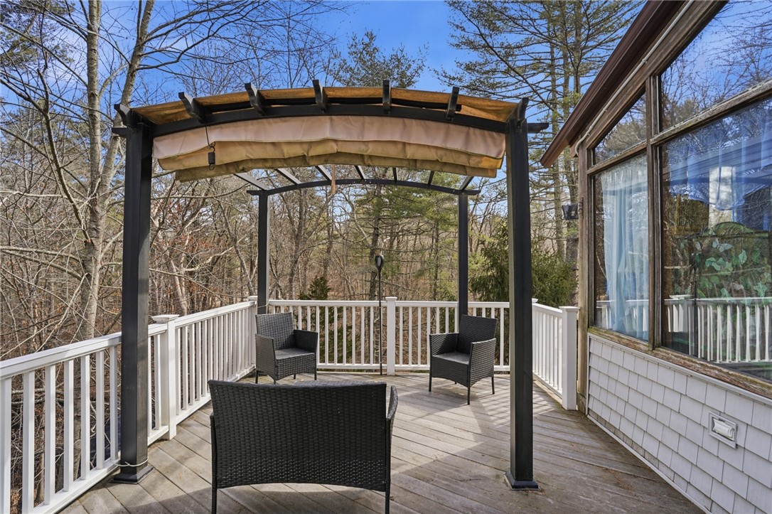 186 Arcadia Road Hopkinton, RI 02832 - Photo 14 of 27 Enjoy the expansive first-floor deck, where you can immerse yourself in the breathtaking views of the surrounding natural landscape and the picturesque Wood River, creating an idyllic outdoor living space.