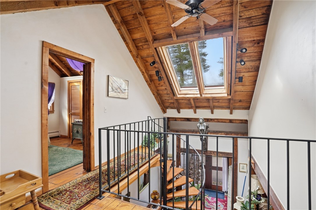 186 Arcadia Road Hopkinton, RI 02832 - Photo 16 of 27 2nd floor landing with seating area perfect for relaxing or reading a book, bathed in natural light from multiple skylights during the day and under the moonlight at night.
