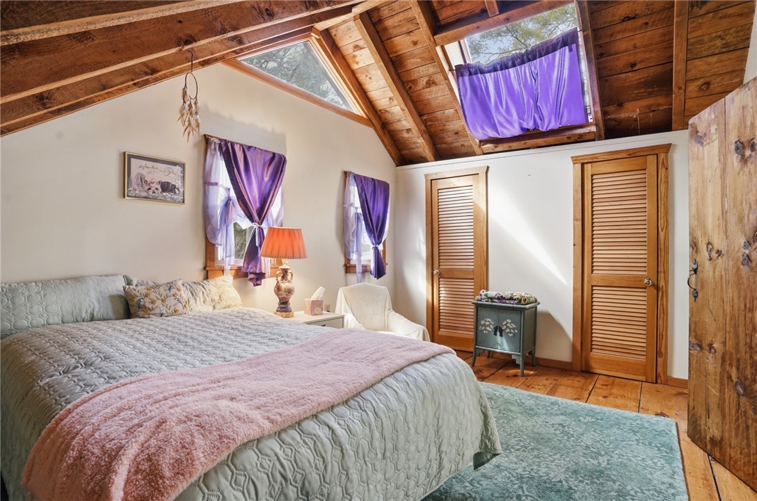 186 Arcadia Road Hopkinton, RI 02832 - Photo 19 of 27 Spacious bedroom featuring a generously sized walk-in closet and skylights, providing abundant natural sunlight throughout the day and moonlight and star gazing opportunities during the evening hours.