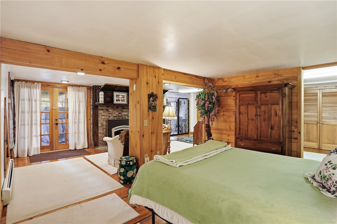 186 Arcadia Road Hopkinton, RI 02832 - Photo 23 of 27 This flexible lower-level bedroom, which is currently configured as a third bedroom, offers an opportunity to be easily closed off for privacy or seamlessly integrated into the living space. As is, it provides a direct connection to a comfortable seating area, highlighted by the inviting ambiance of the fireplace, and easy access to the outdoor deck and bonus room. You'll also find the second full bath and dressing room large enough to create an small bedroom if desired.