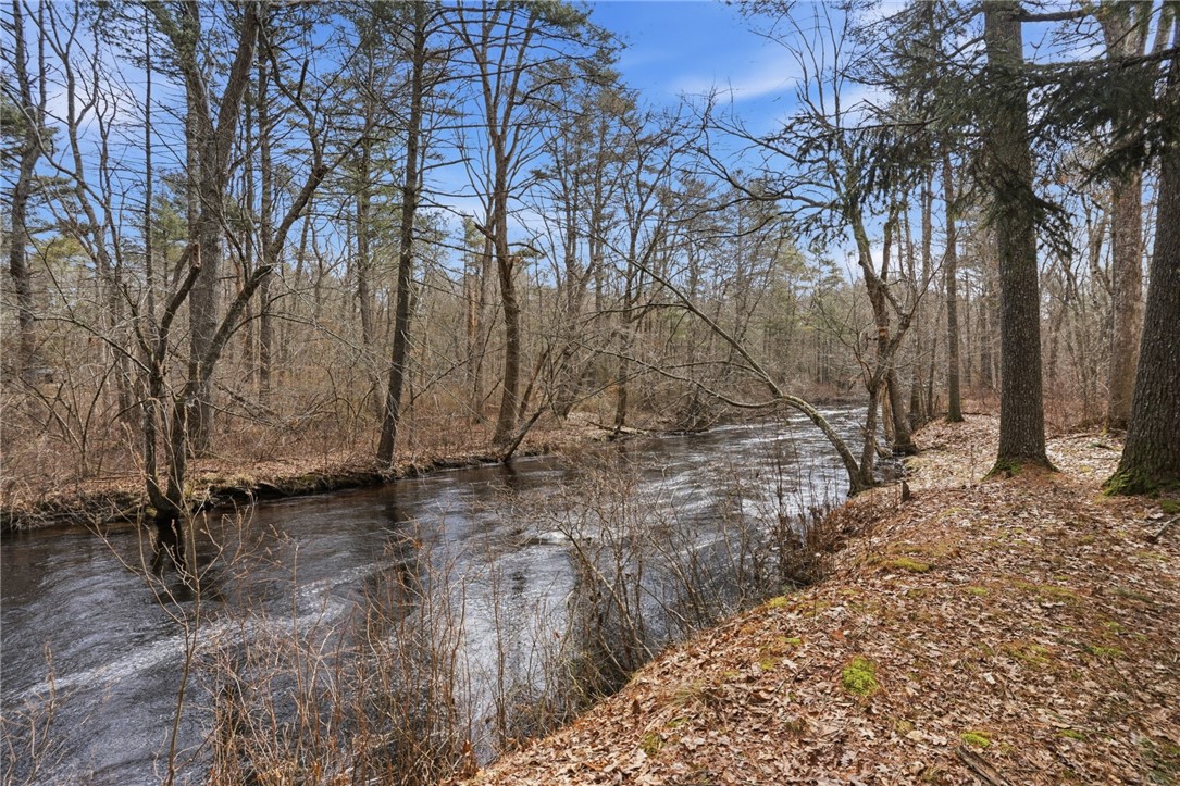 186 Arcadia Road Hopkinton, RI 02832 - Photo 27 of 27 Enjoy the serenity of riverfront views from this exceptional property, where lush natural landscapes create a peaceful setting, with privacy and unparalleled access to nature.