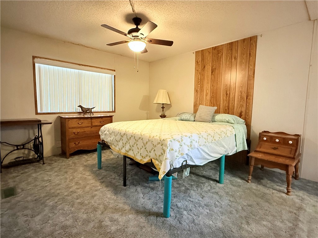 1637 Talc Road Bullhead City, AZ 86442 - Photo 17 of 37 Carpeted bedroom with a textured ceiling and ceiling fan