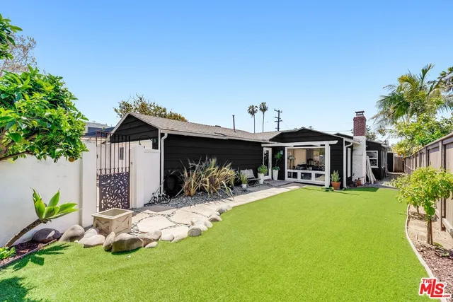 a view of a house with backyard porch and sitting area