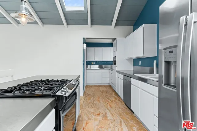 a kitchen with a stove and a refrigerator