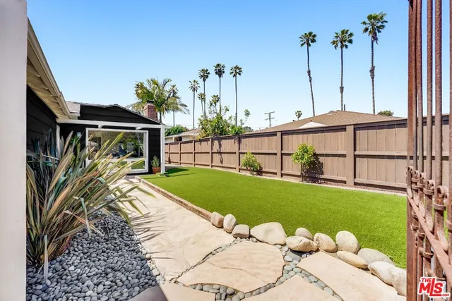 a view of a backyard with sitting area