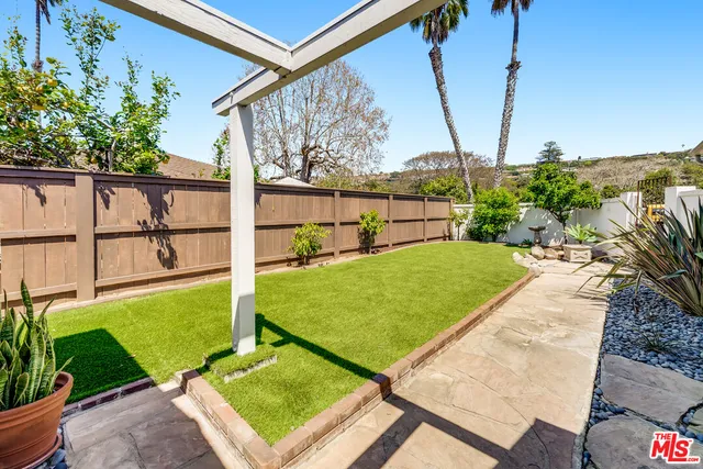 a view of a backyard with chairs