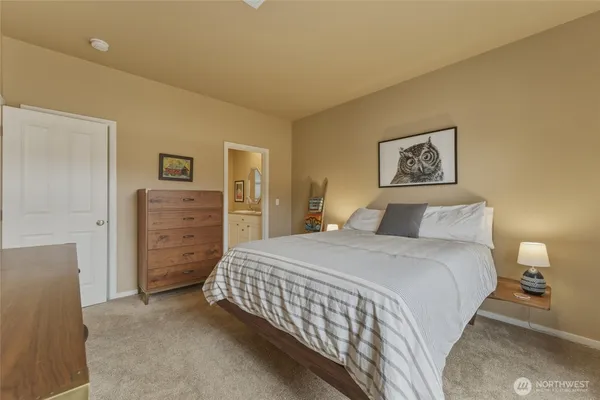 a bedroom with a bed and a lamp